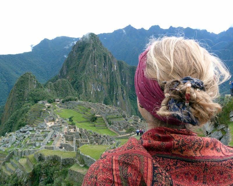 girl on her back with machu picchu in the background