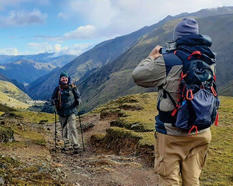 two boys with backpacks taking a picture in the lares valley