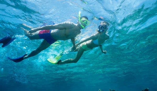 casal mergulhando com snorkel em La Fe