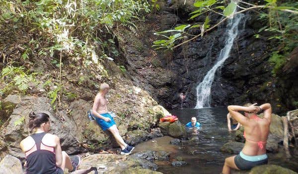 Reisende im Wasserfall von Rio Claro