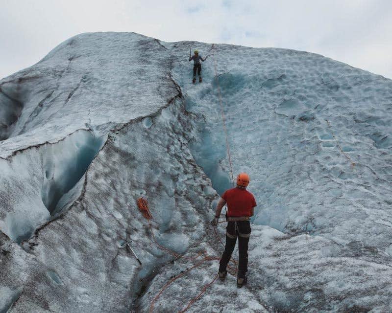 führer hilft beim eisklettern auf dem skaftafell gletscher