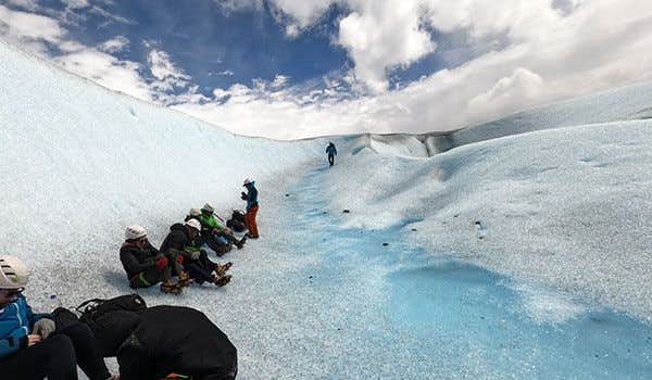 group sitting on the glacier having lunch together