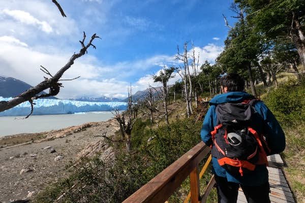 people on the side of the perito moreno glacier during mini trekking
