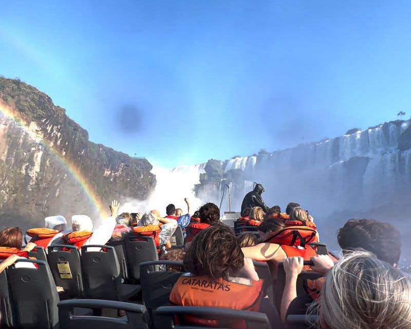 people on the speedboat observing the falls