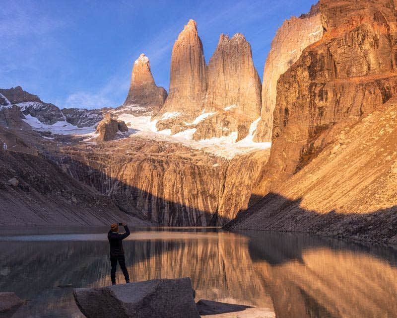 traveler photographing torres del paine