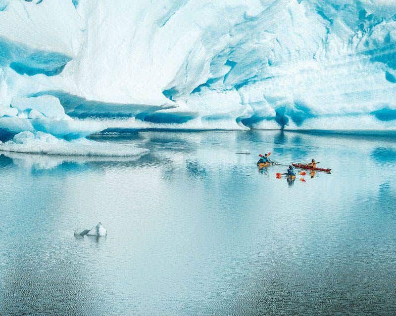 kayaks beside the iceberg