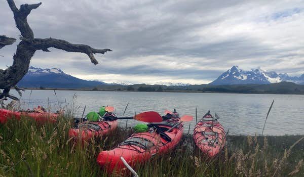kayaks besides the grey lake