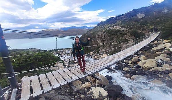 girl on the suspension bridge over the lake