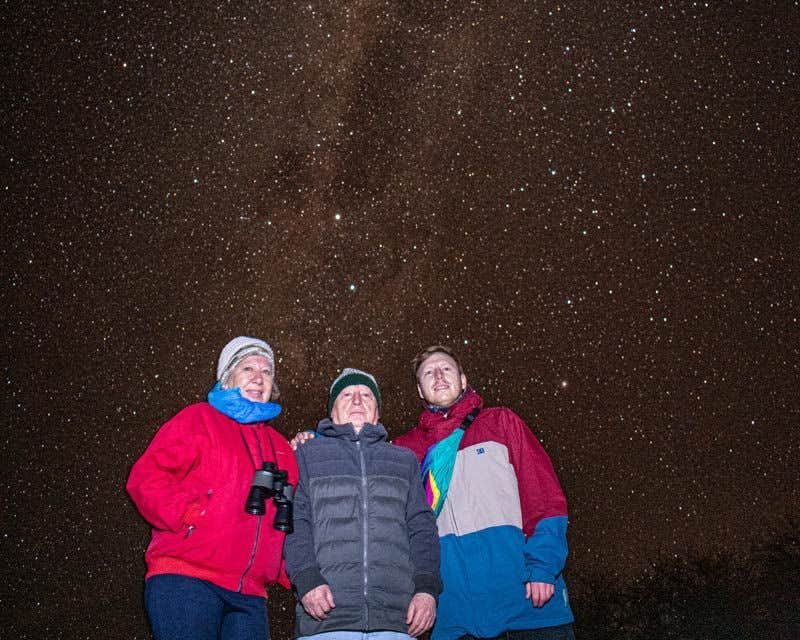 three friends enjoying the astronomical tour of san pedro de atacama
