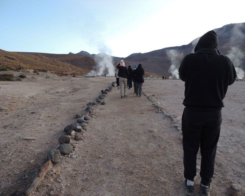 walking group observing the geysers 
