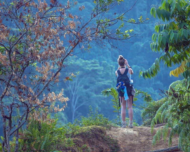 girl taking a photo on the trek to the lost city of colombia