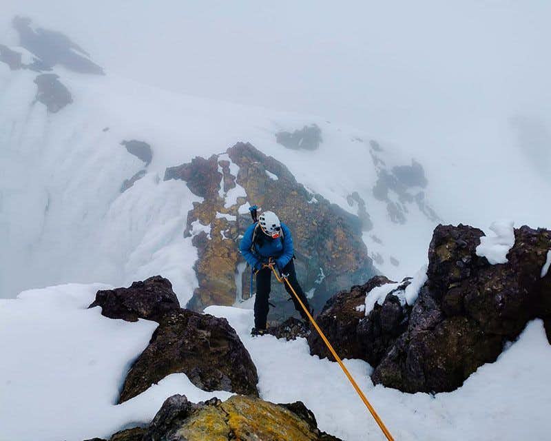 mountaineer in rope making the ascent to carihuairazo