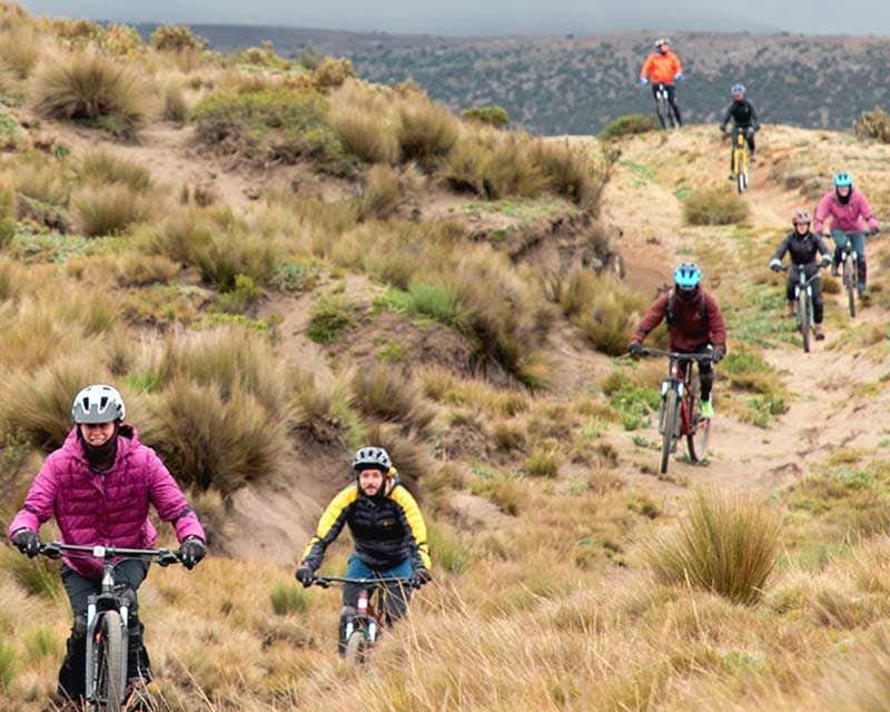 group of cyclists descending the volcano chimborazo