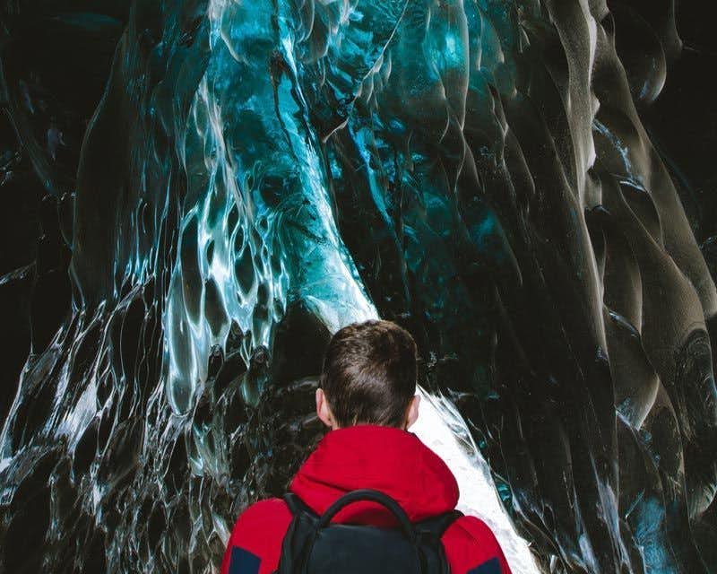 boy in the sapphire blue ice cave