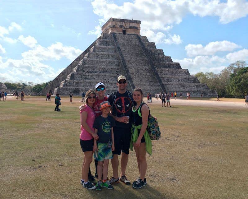 family in the chichen itza pyramid