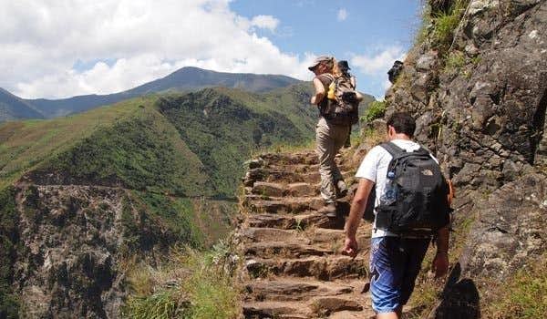 couple walking up the stairs on the way to machu picchu from aguas calientes