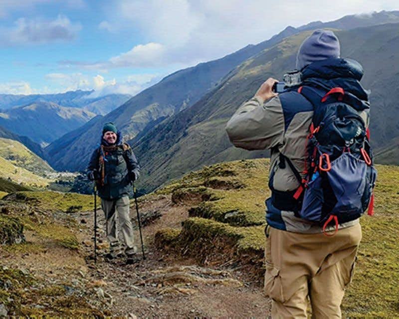 two boys with backpacks taking a photo in the lares valley