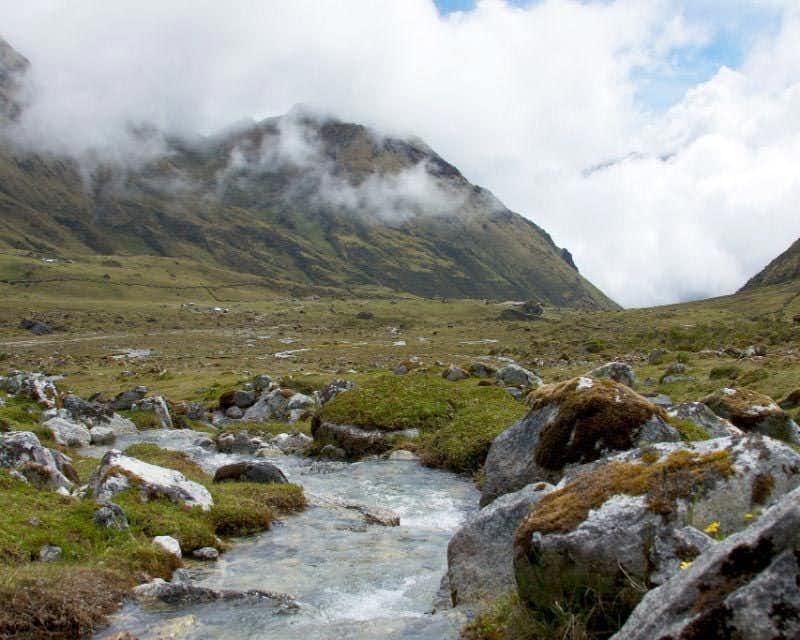 Stream between mountains in the valley of the Salkantay trek premium trek