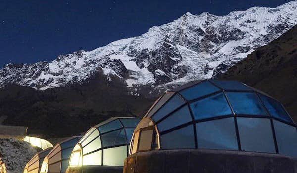 Crystal igloos with snow-capped mountain in the background during the Salkantay trek sky lodge