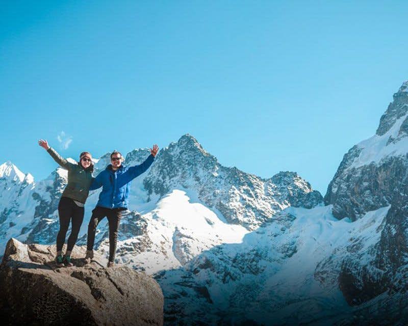 couple in front of the salkantay mountain in the salkantay trek sky lodge 5 day trek