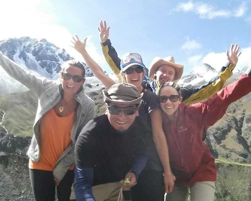 group and guide smiling in the salkantay trek sky domes 5 days