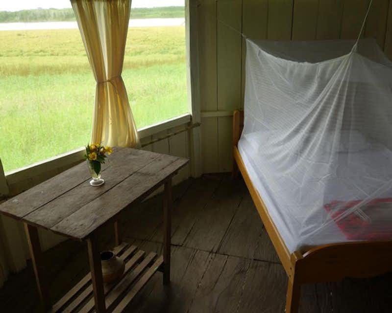 Bed with mosquito net in the private room of the Iquitos Jungle lodge