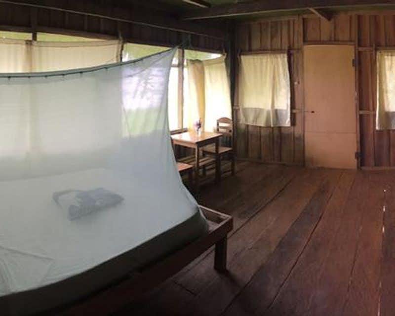 Bed in the room of the lodge in the jungle of Iquitos