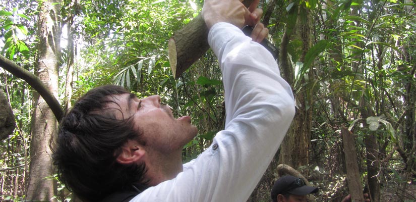 guy drink water from a liana in peruvian jungle