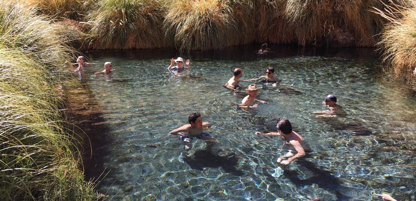 People swimming in the Termas de Puritama