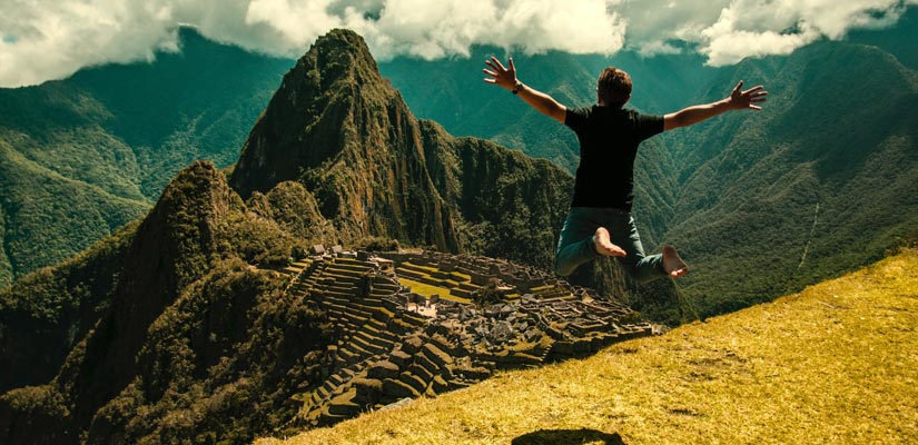 chico saltando en machu pichu en guia de viaje por Cusco