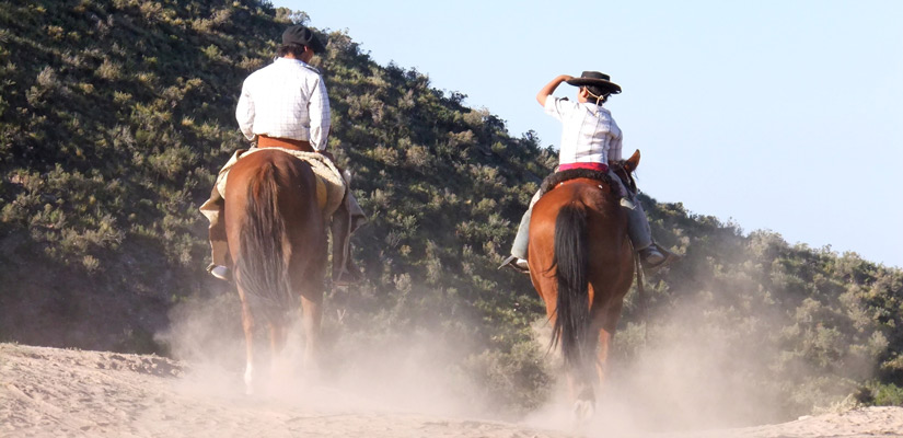 two people on horseback at gaucho day party in buenos aires