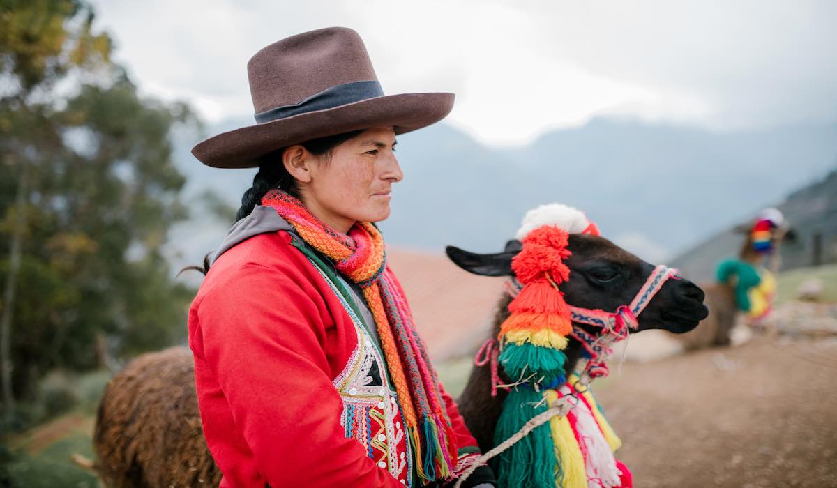 Indigenous woman with a llama