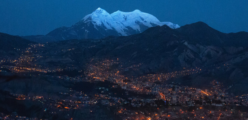 night views of la paz with snow-capped mountain in the background