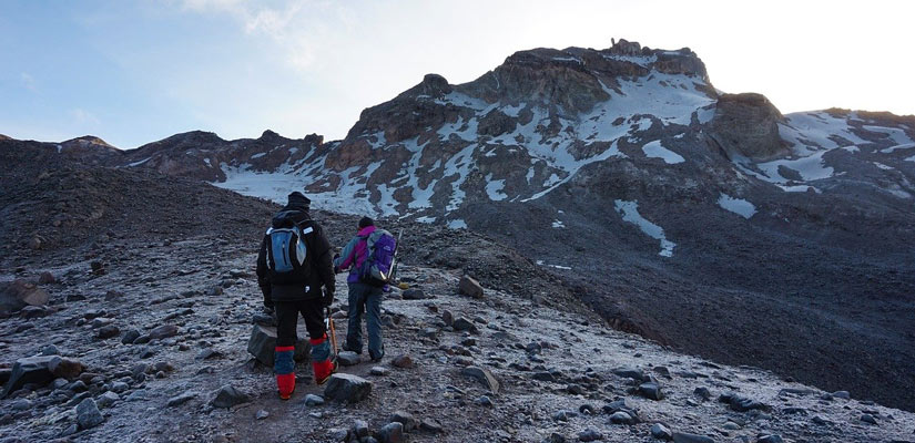 two people trekking to the carihuairazo volcano in ecuador